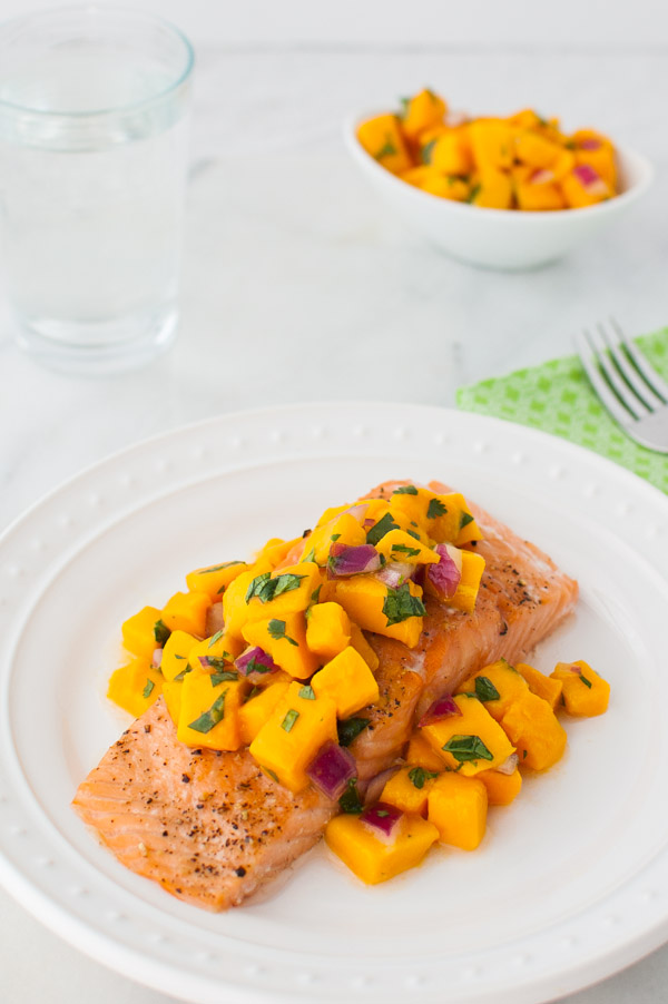 Roasted Salmon with Mango Salsa - Oven roasted salmon topped with a bright, sweet, and spicy mango salsa. | tamingofthespoon.com