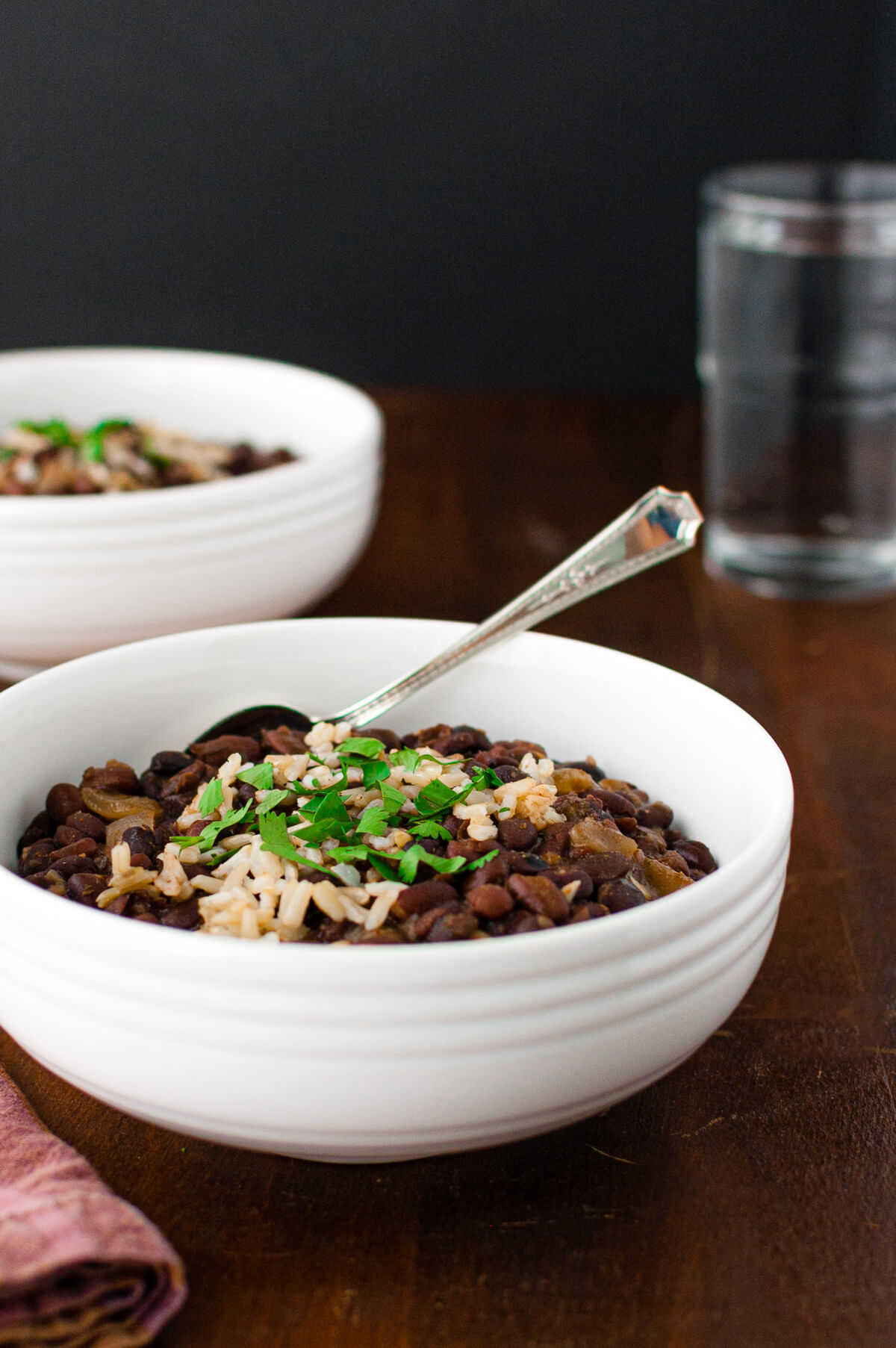 Close-up of bowl of black bean soup garnished with chopped cilantro.