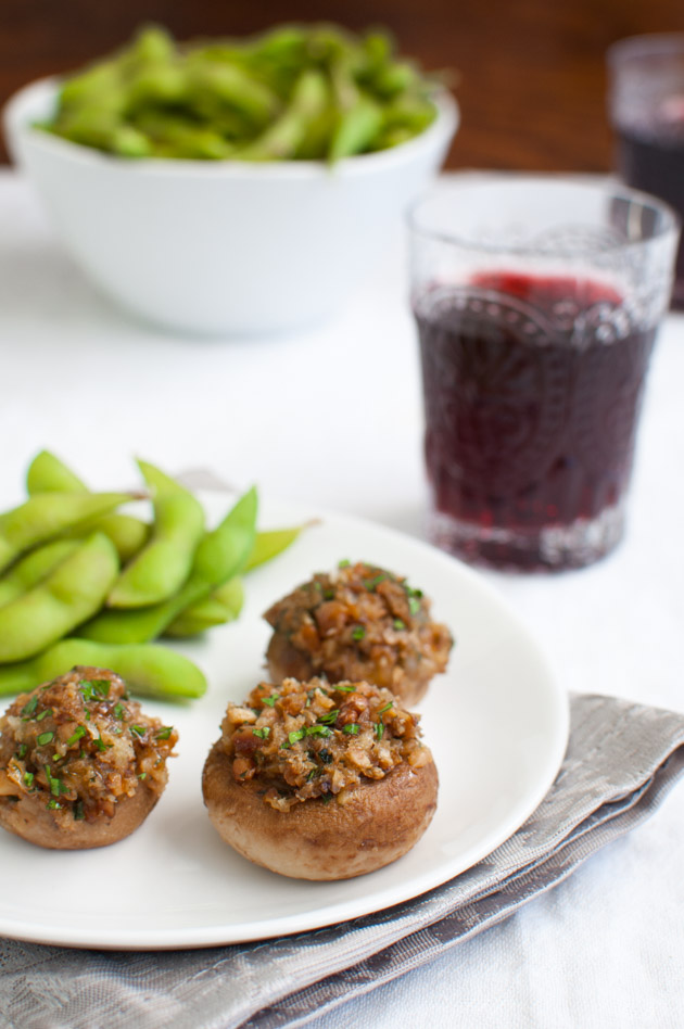 Mushrooms stuffed with cheddar cheese, walnuts, and onions served with some edamame and red wine.