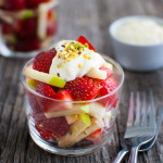 Strawberry and apple salad in a glass cup.