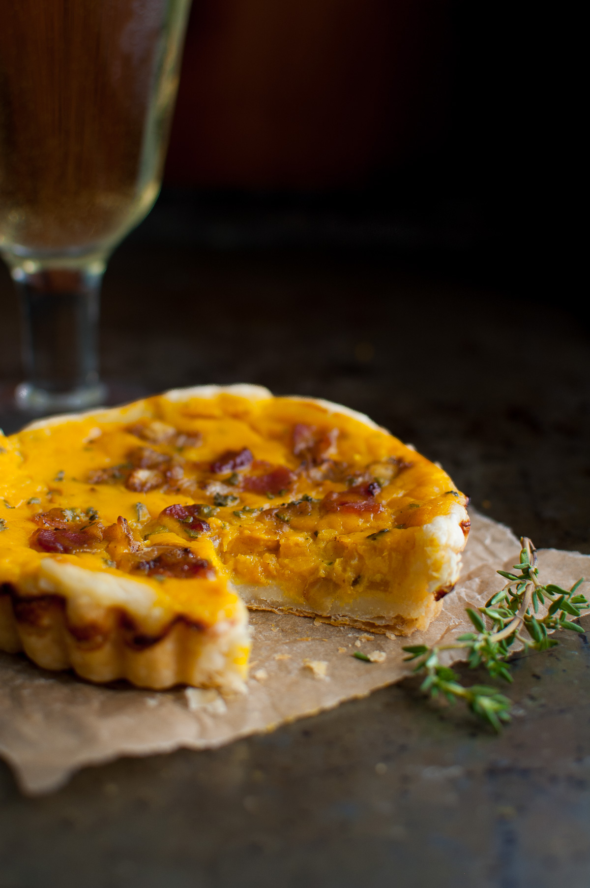 A butternut squash tart with a wedge cut out.