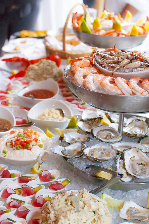 Table piled with a variety of seafood on a bed of ice.