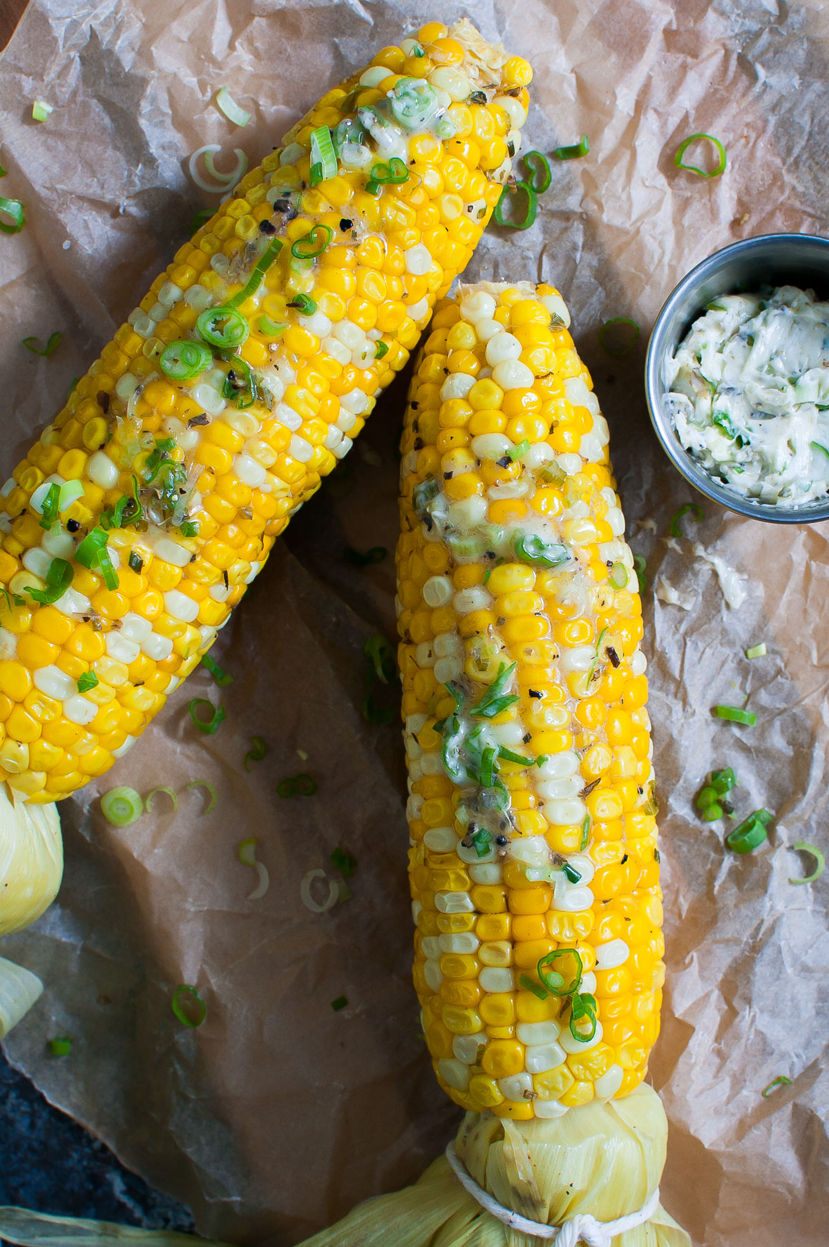 Two ears of grilled corn slathered with southwest butter.