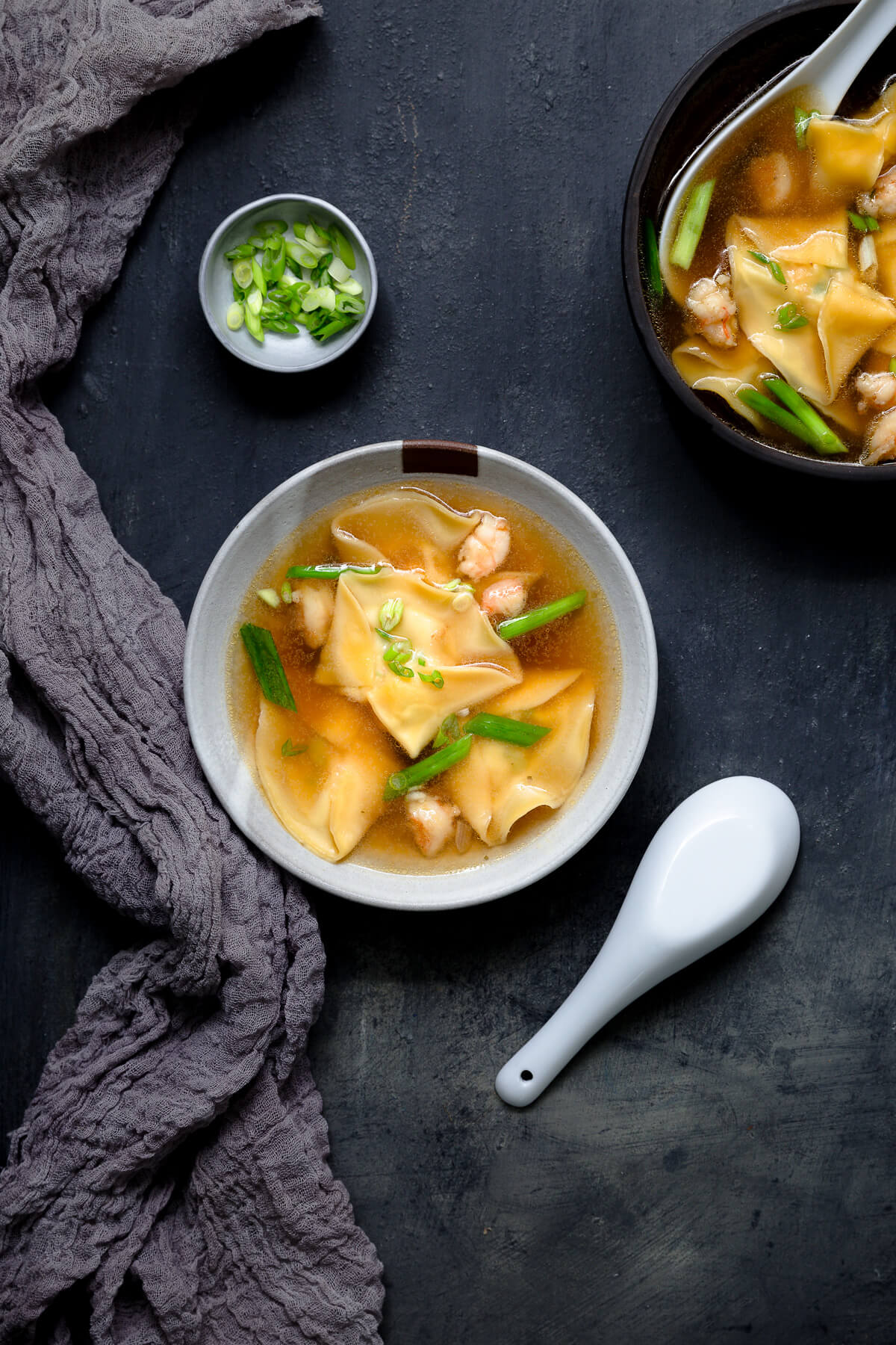 Overhead shot of two bowls of shrimp dumpling soup.