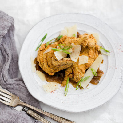 Fried quail on a white plate.