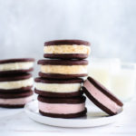 A stack of ice-cream sandwiches on a white plate.