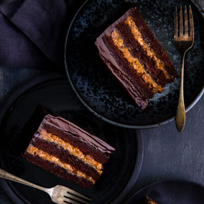 Slices of Inside-out German chocolate cake on black dessert plates.