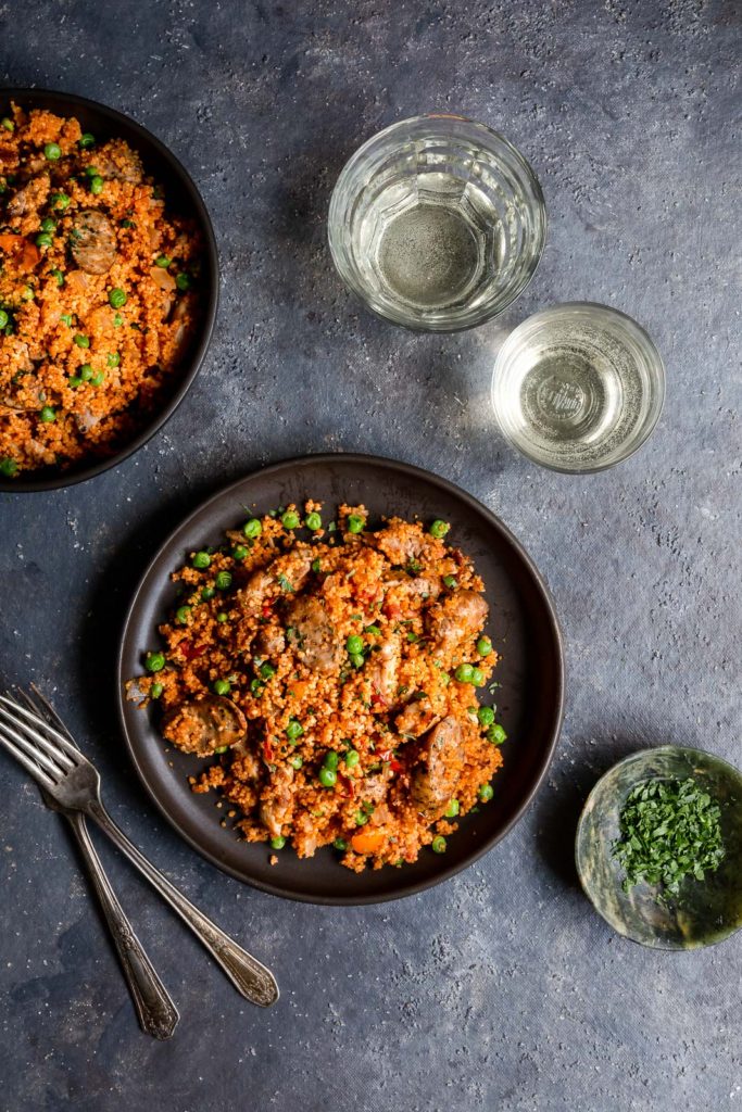 Chicken and Sausage Paella with Couscous - authentic paella flavors made quick and easy with couscous and boneless chicken thighs. Great for a weeknight dinner!