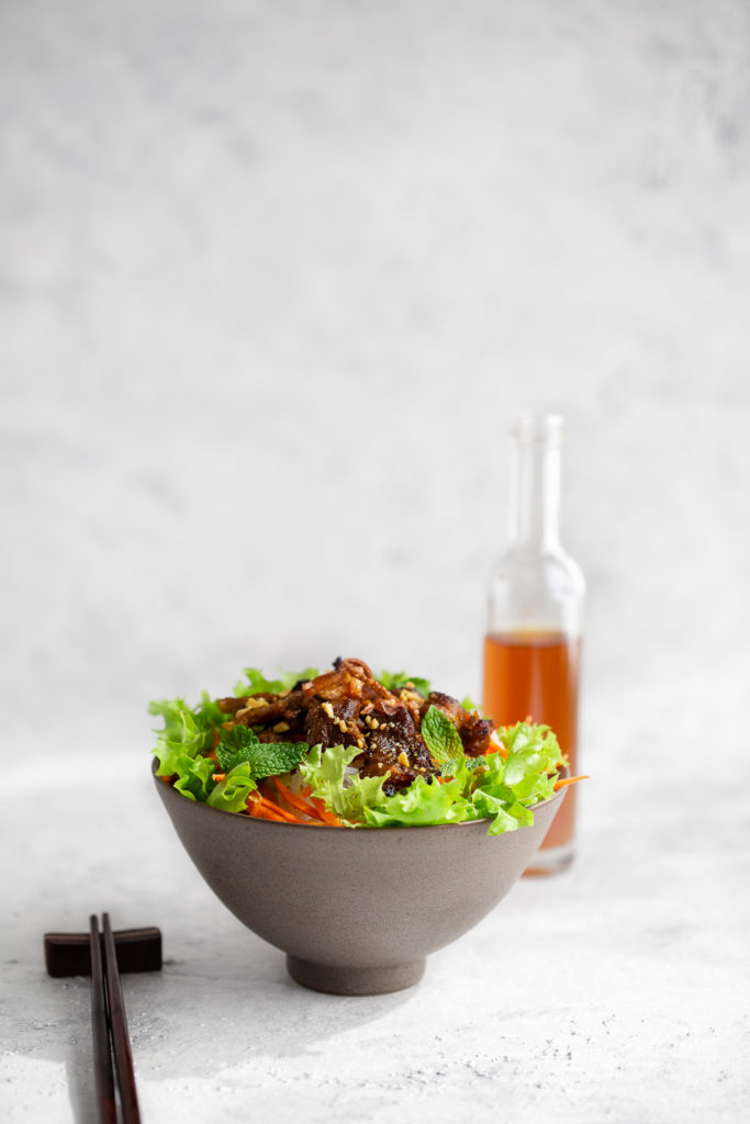 Authentic Vietnamese rice noodle bowl with marinated grilled pork and served with lots of fresh vegetables and a fish sauce dipping sauce.