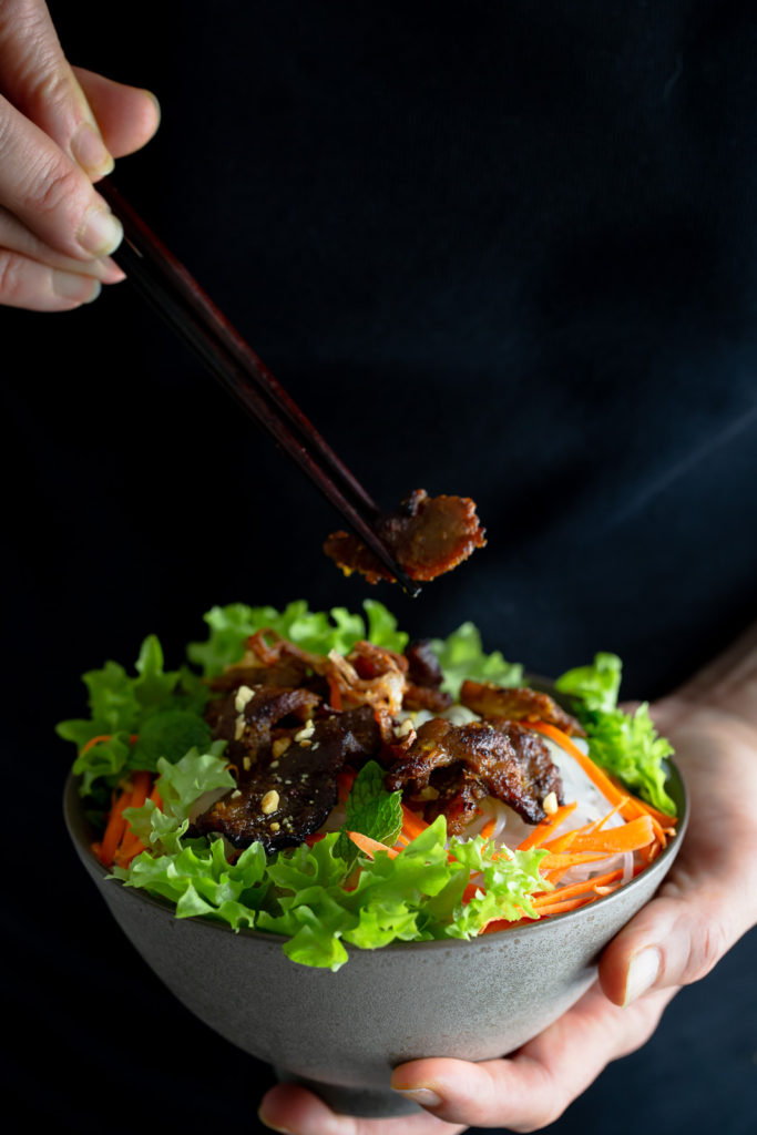 Authentic Vietnamese rice noodle bowl with marinated grilled pork and served with lots of fresh vegetables and a fish sauce dipping sauce.