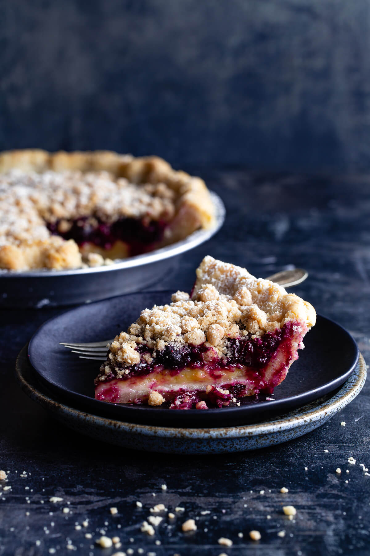 A slice of lemon-blueberry streusel pie on a plate.