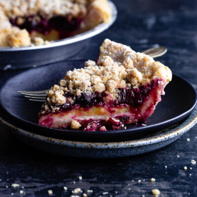 A slice of lemon-blueberry streusel pie on a plate.