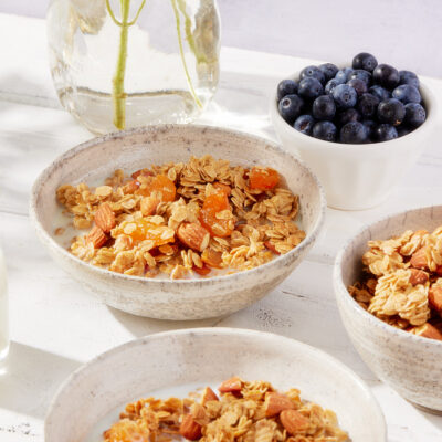 Close-up of bowl of almond granola with dried apricots.