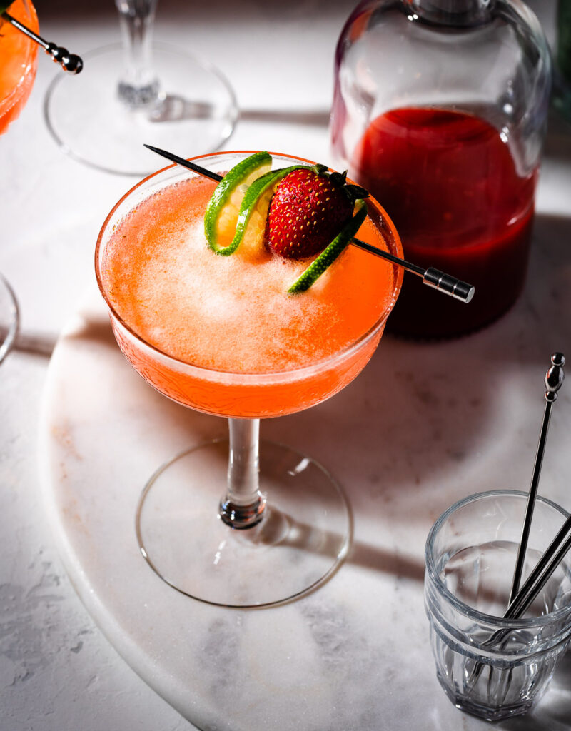 Top view of a strawberry mocktail in a coupe glass.