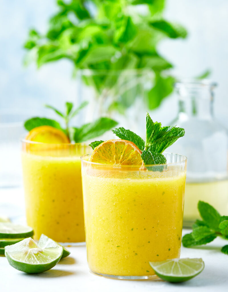 Two glasses of frozen mango mojito.