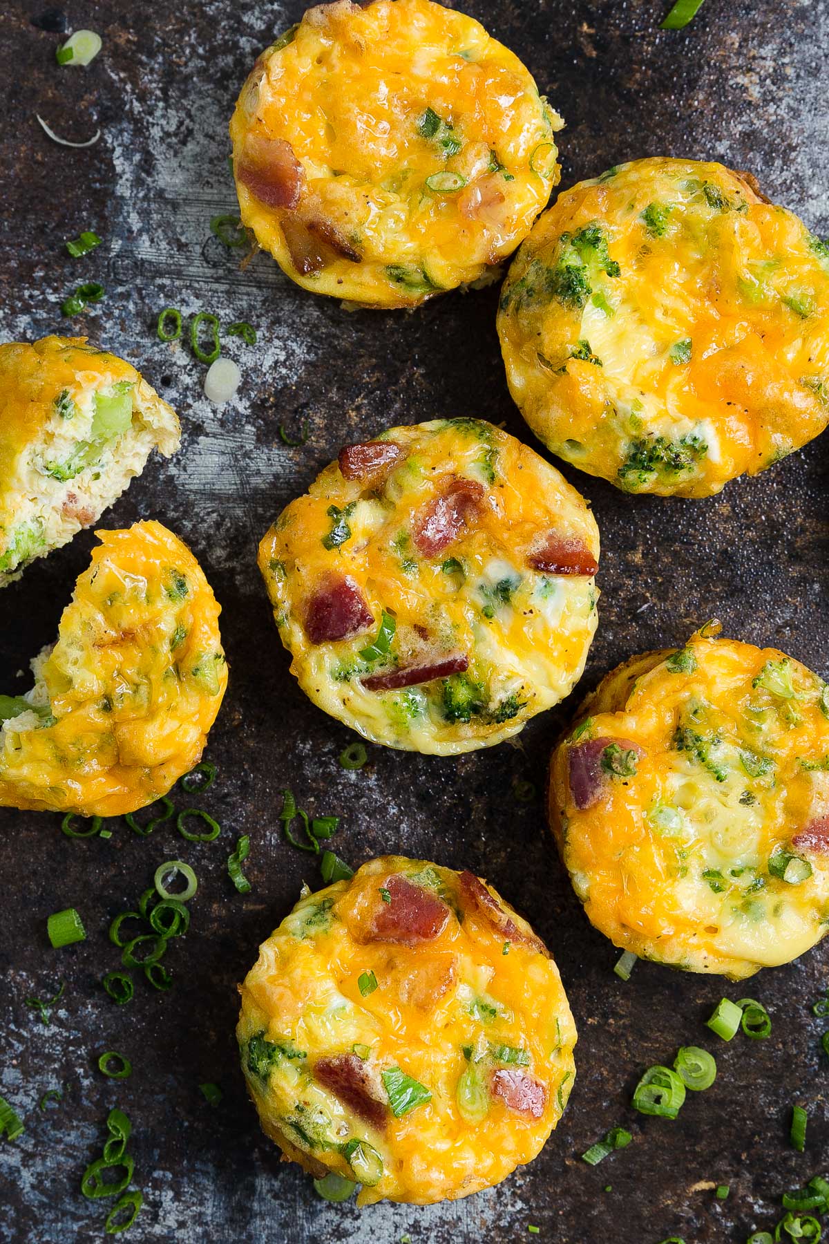 Close-up of mini frittatas on a wooden board.