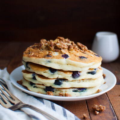 A stack of blueberry pancakes topped with some streusel.