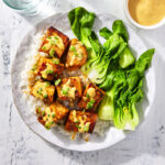 Honey sriracha salmon bites topped with some sriracha mayo sauce and chopped green onions.